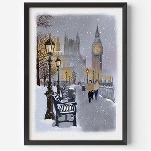 May include: Watercolor painting of a snowy London scene. The artwork features Big Ben, the Houses of Parliament, and street lamps. Two figures walk along a snow-covered path. The painting is framed in a black border.