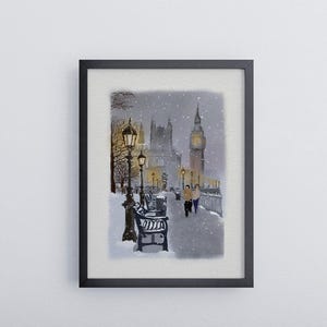May include: A framed watercolor painting depicts a snowy scene in London. The artwork features Big Ben, street lamps, benches, and two figures walking along a snow-covered path. The painting is set in a black frame.