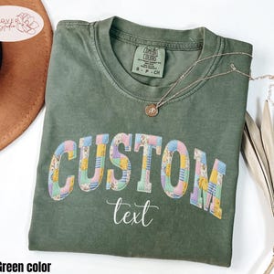 May include: A set of three ceramic mugs with a speckled, matte finish. The mugs are in shades of cream, light gray, and dark gray. Each mug has a simple, minimalist design, perfect for coffee or tea.