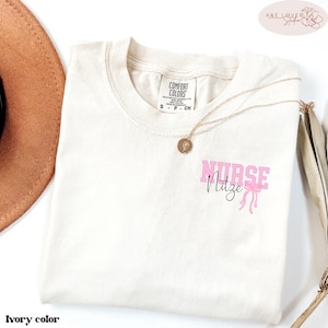 Custom Name Gift For Nurses, Healthcare Workers Comfort Color t-Shirt, Pink bow and nurse's name pocket design, Coquette nurse gift t-Shirt.