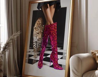 May include: A framed art print featuring a leopard and a pair of high-heeled boots with a pink and orange animal print. The boots are knee-high and have a pointed toe. The background is a black and white checkered floor.