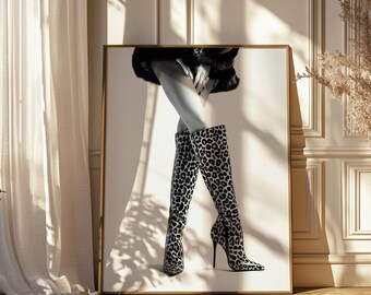 May include: A pair of black and white leopard print boots with stiletto heels. The boots are worn by a person standing on a white background.