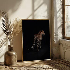 May include: A black and white photograph of a leopard in a dark setting. The leopard is facing to the right and is standing on all fours. The leopard's spots are clearly visible.