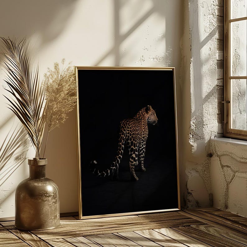 May include: A black and white photograph of a leopard in a dark setting. The leopard is facing to the right and is standing on all fours. The leopard's spots are clearly visible.
