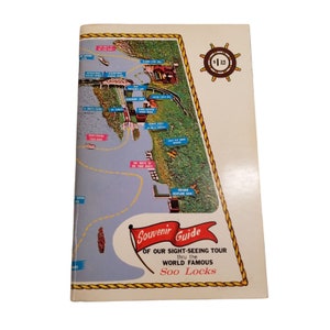May include: A vintage souvenir guide map of the Soo Locks in Sault Ste. Marie, Michigan. The map shows the route of the tour boats, the location of the locks, and other points of interest. The guide is priced at $1.25.