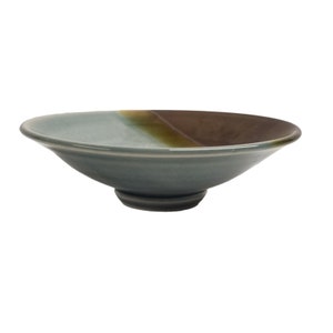 May include: A light blue and brown ceramic bowl with a wide rim and a small foot. The bowl has a glaze that creates a subtle colour gradient.