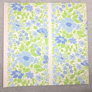 May include: A vintage wallpaper design featuring a repeating pattern of blue and green flowers on a white background.