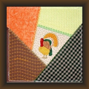 May include: A patchwork quilt square with a brown, orange, and green background. A colorful embroidered turkey is in the center of the square.