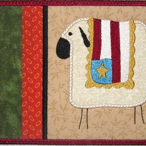 May include: A white sheep with a red, white, and blue flag draped over its back. The flag has a blue star in the center. The sheep is standing on a tan background with a brown, green, and orange patterned border.
