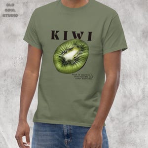 Green Y2K aesthetic unisex t-shirt featuring a bold KIWI text, a vibrant kiwi graphic, and small retro-inspired text below. A tropical, playful vibe perfect for casual, streetwear looks