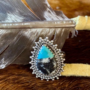 A Beautiful White Buffalo and Turquoise native ring. Set in sterling sliver with rope and bead design size 7