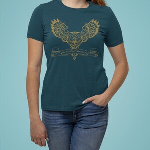May include: Teal blue t-shirt featuring a gold owl graphic and the text "You Have To Trust Your Own Magic".