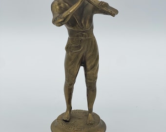 Vintage solid brass Pipe Piper Boy playing a flute