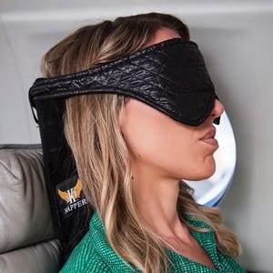May include: A black sleep mask with a quilted design and a strap that goes around the head. The strap has the text "K Mapper" printed on it.