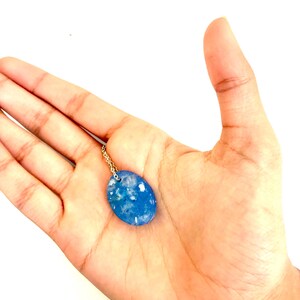 Handmade light blue oval silvery resin necklace