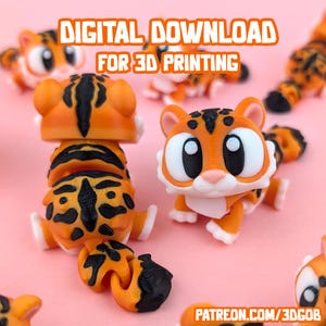 Puede incluir: Varias figuras de tigre naranja y negro impresas en 3D. Los tigres tienen ojos blancos grandes, narices rosas y rayas negras. El texto "DESCARGA DIGITAL PARA IMPRESIÓN 3D" está en la parte superior.
