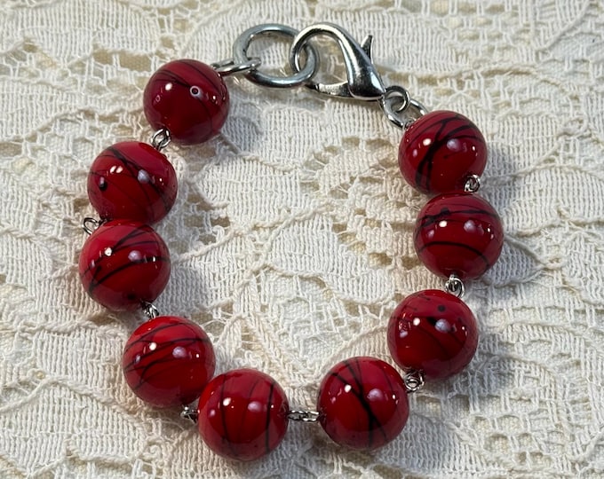 Fiery Red Beaded Bracelet – Bold Statement Jewelry with Black Swirl Accents