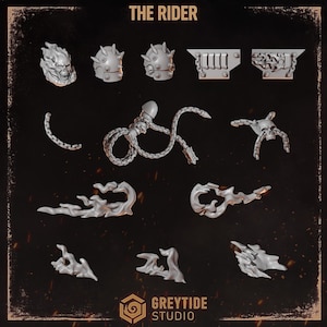 May include: A collection of grey miniature gaming components titled THE RIDER by GREYTIDE STUDIO. The set includes a flaming skull head, spiked shoulder pads, chain segments, a skull with chains, and various flame-shaped accessories for figures.