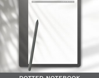 May include: A digital tablet with a white dotted notebook screen and a stylus. The tablet is dark gray, and the screen has a grid of small dots. The stylus is black and angled towards the screen. The text "DOTTED NOTEBOOK" is at the bottom.