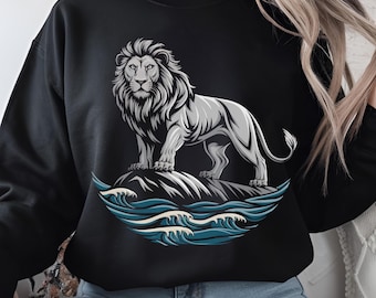 May include: Black sweatshirt with a white lion graphic standing on a rock with blue waves behind it.