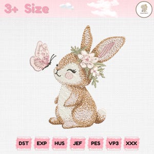May include: An embroidered design of a smiling bunny with a floral crown and a butterfly. The bunny is brown and white, with pink accents in its ears and on the butterfly. The text "3+ Size" is at the top, and embroidery file formats are listed at the bottom.