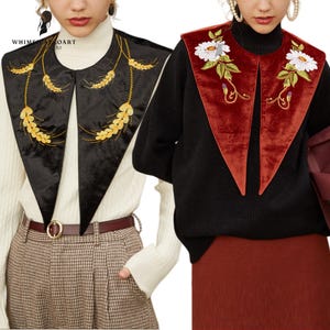 May include: Two velvet collar accessories. One is black with gold embroidery, the other is red with white floral embroidery. Both are worn over sweaters. The collars are a unique fashion statement.