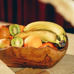 Artistic Display of Olive Wood Rustic Fruit Cup styled with vibrant fruits, emphasizing its rustic charm and functionality.