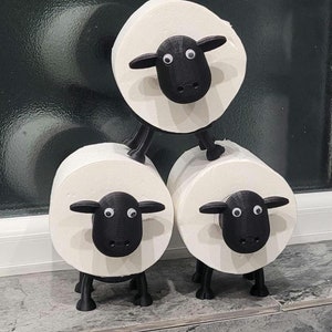 sheep toilet roll holders designed to be fitted into inner toilet roll or loo rolls as a fun sheep holder. googley eyes and black colour. 4 legs with a base and head. no mouth variation.