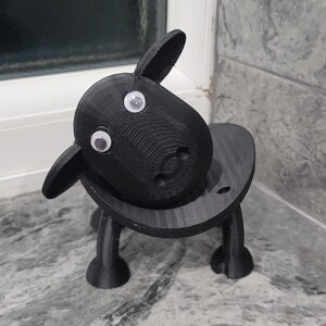 sheep toilet roll holders designed to be fitted into inner toilet roll or loo rolls as a fun sheep holder. googley eyes and black colour. 4 legs with a base and head. no mouth variation.