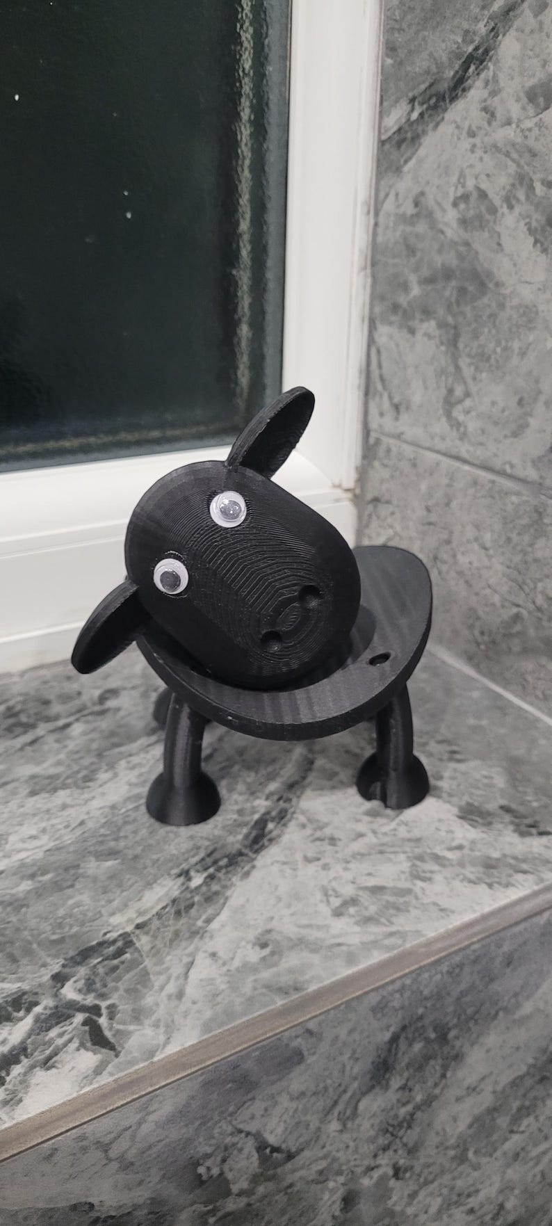 sheep toilet roll holders designed to be fitted into inner toilet roll or loo rolls as a fun sheep holder. googley eyes and black colour. 4 legs with a base and head. no mouth variation.
