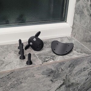 sheep toilet roll holders designed to be fitted into inner toilet roll or loo rolls as a fun sheep holder. googley eyes and black colour. 4 legs with a base and head. no mouth variation.