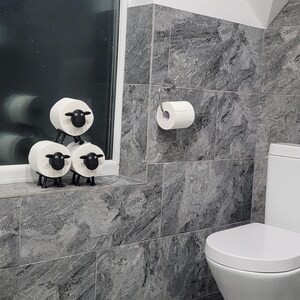 sheep toilet roll holders designed to be fitted into inner toilet roll or loo rolls as a fun sheep holder. googley eyes and black colour. 4 legs with a base and head. no mouth variation.