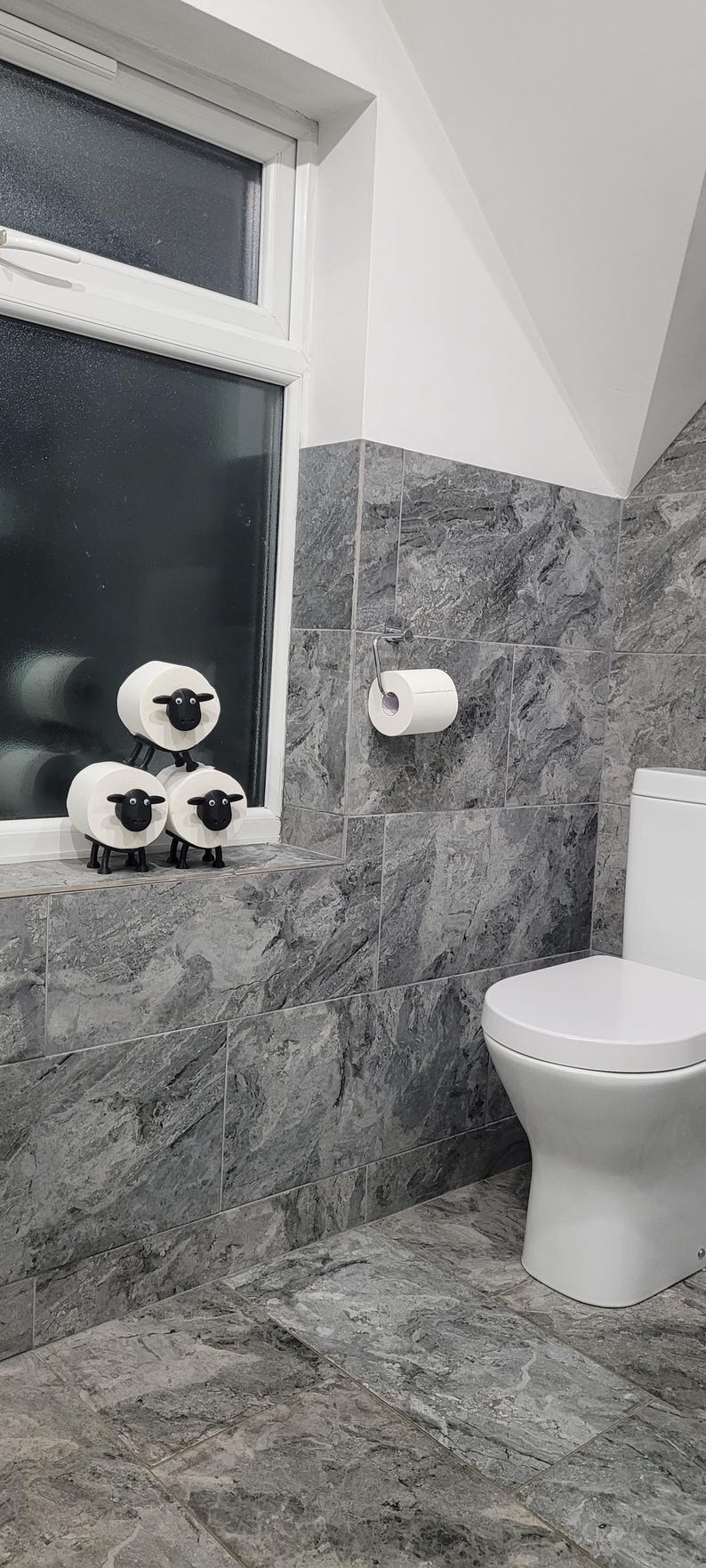 sheep toilet roll holders designed to be fitted into inner toilet roll or loo rolls as a fun sheep holder. googley eyes and black colour. 4 legs with a base and head. no mouth variation.