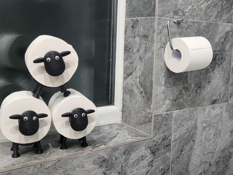 sheep toilet roll holders designed to be fitted into inner toilet roll or loo rolls as a fun sheep holder. googley eyes and black colour. 4 legs with a base and head. no mouth variation.