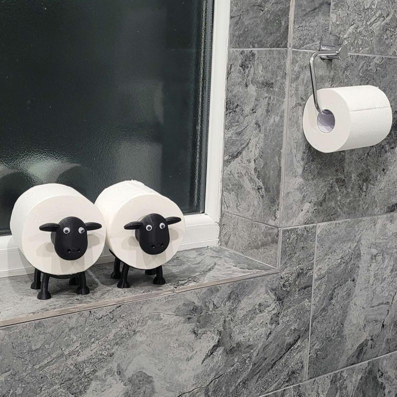 sheep toilet roll holders designed to be fitted into inner toilet roll or loo rolls as a fun sheep holder. googley eyes and black colour. 4 legs with a base and head. no mouth variation.