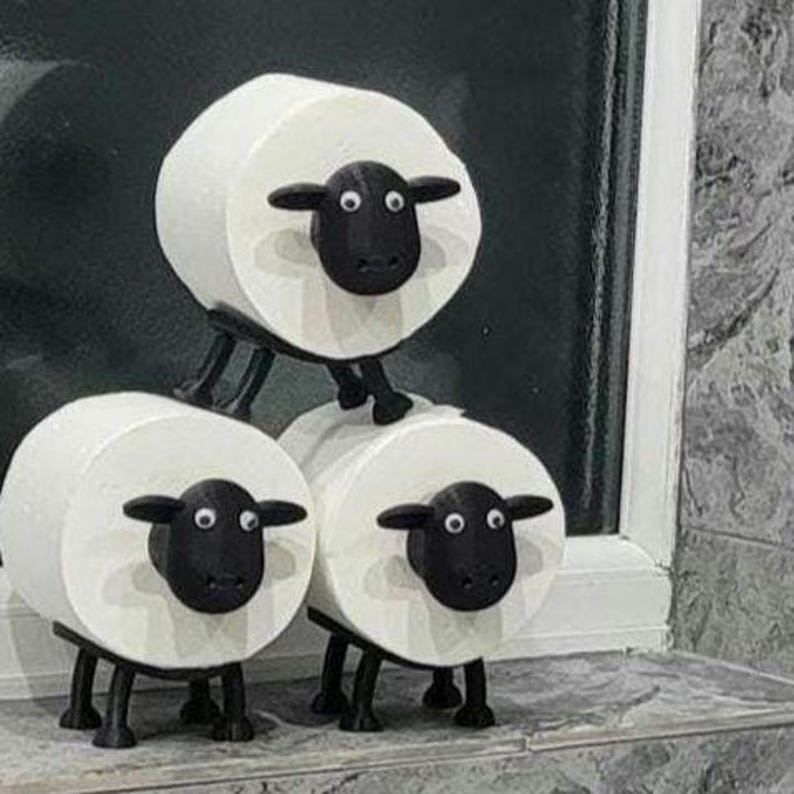 sheep toilet roll holders designed to be fitted into inner toilet roll or loo rolls as a fun sheep holder. googley eyes and black colour. 4 legs with a base and head. no mouth variation.