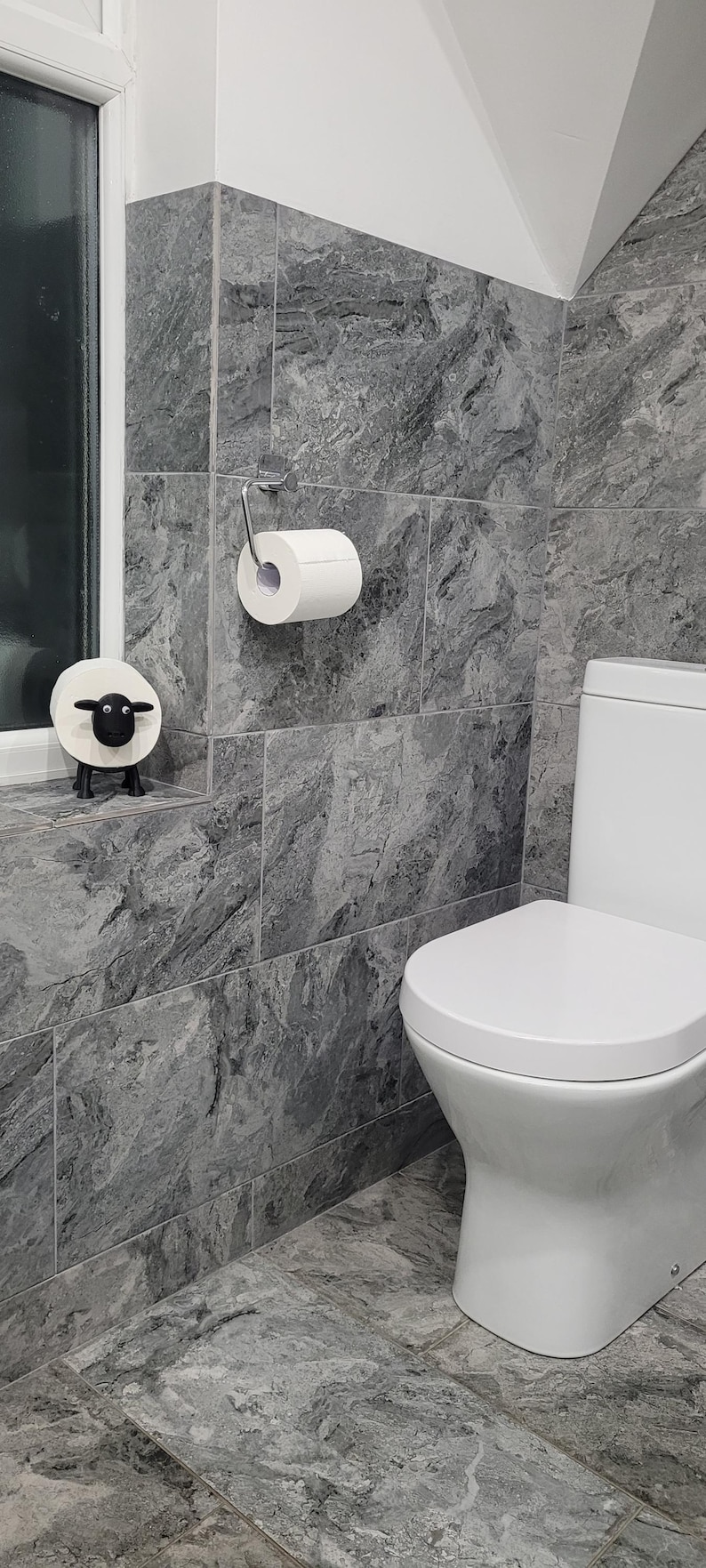 sheep toilet roll holders designed to be fitted into inner toilet roll or loo rolls as a fun sheep holder. googley eyes and black colour. 4 legs with a base and head. no mouth variation.