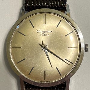 montre vintage ULTRA fine Dugena Festa pour homme.  Bracelet en cuir neuf, acier inoxydable edelstahl 13313 (numéro de boîtier).  Superbe !