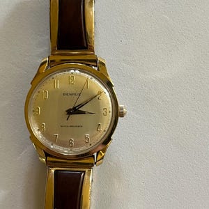 Mans Benrus wrist watch 20 microns gold electroplate ss back water proof, shock proof raised number dial very attractive semi flex band 37mm