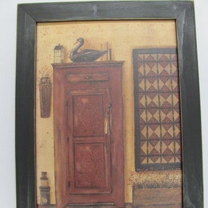 May include: A framed print of a country kitchen scene with a red cabinet, a black swan, and a quilt hanging on the wall.