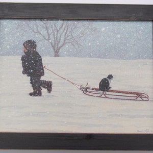 May include: A child wearing a black coat pulls a red sled through a snowy field. A black and white cat sits on the sled, looking ahead.