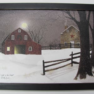 May include: A snowy winter scene with a red barn and a stone house. The barn has a light on in the window and the house has a red star on the side. The text "A Light in the Stars" is written in the bottom left corner of the image.