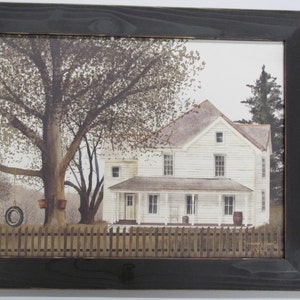 May include: A framed watercolor painting of a white farmhouse with a porch and a swing hanging from a tree in the front yard. The house has a white picket fence and a brown roof. The painting is set against a light blue sky with white clouds.