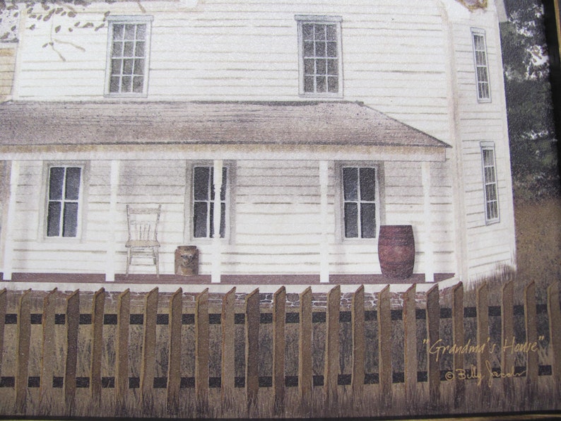 May include: A white farmhouse with a porch and a wooden fence. The house has a brown roof and windows. There is a barrel on the porch and a chair. The text "Grandma's House" is written on the fence.