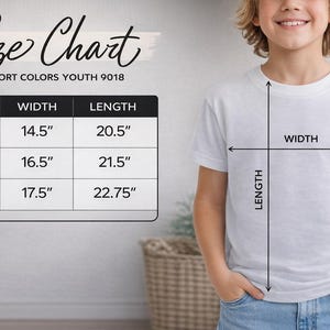 A young boy is standing next to a size chart, smiling and wearing a white t-shirt. The chart provides measurements for different shirt sizes, including S, M, L, and XL, along with corresponding widths and lengths.