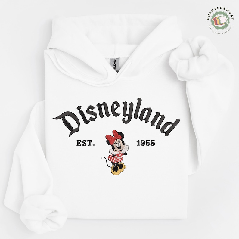 A white hoodie with the text "Disneyland EST. 1955" and a Minnie Mouse graphic printed on it.