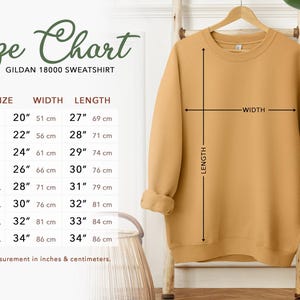 a size chart for a GILLET 1800 sweatshirt, with measurements for different sizes ranging from S to L. The chart includes a diagram of the sweatshirt and a plant in the background.