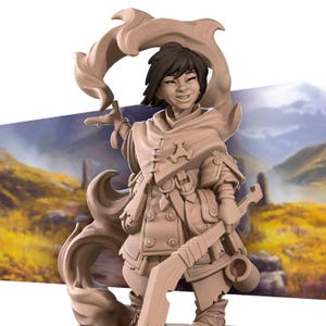 May include: A painted miniature figurine of a female character with brown hair and a brown and tan outfit. She is holding a staff and has a flowing brown cape behind her. The background is a blurry landscape.