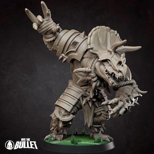 May include: A light brown, unpainted resin miniature of a humanoid triceratops warrior in a dynamic combat pose. The figure wears segmented plate armor, spiked greaves, and arm guards. The Bite the Bullet logo is visible in the bottom left corner.
