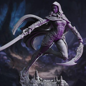 May include: A detailed, gray figurine of a female warrior in a dynamic pose, holding two curved blades. She wears a hooded cloak and armor with intricate designs. The figure is posed on a rocky base, suggesting a fantasy theme.
